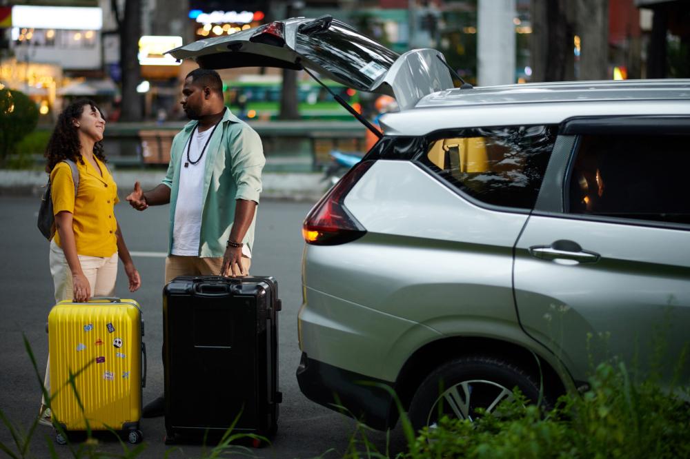 woman standing with man with luggage near his car he rents out in order to earn passive income with no money